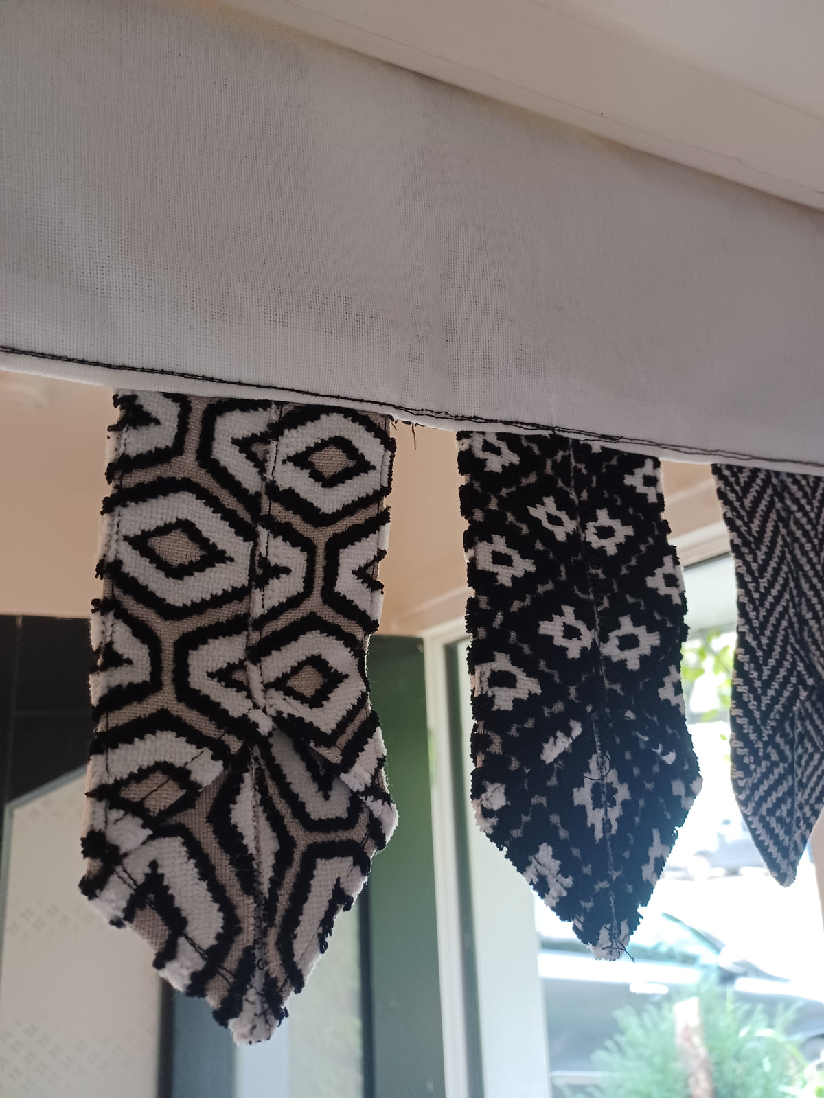 Handmade toran door hanging in shades of black and off-white