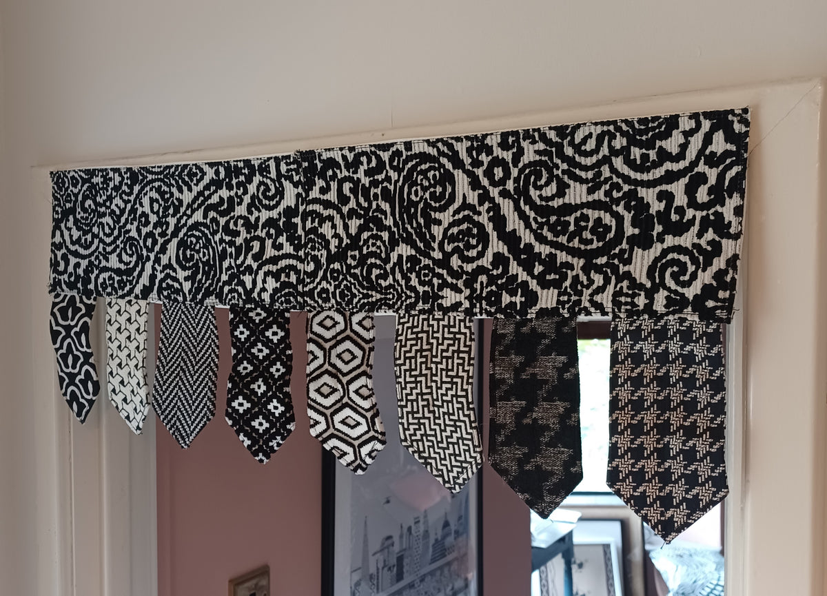 Handmade toran door hanging in shades of black and off-white