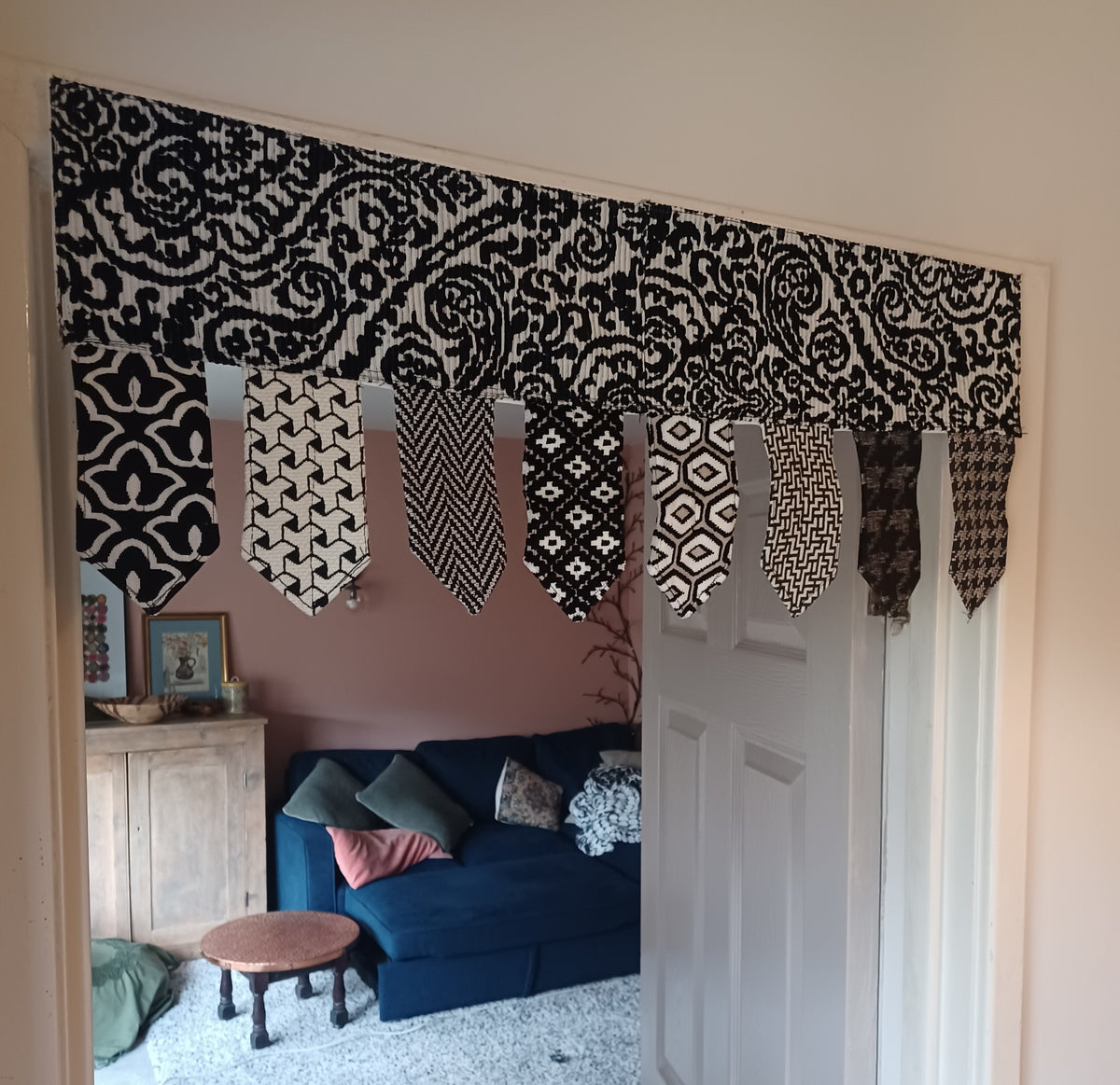 Handmade toran door hanging in shades of black and off-white