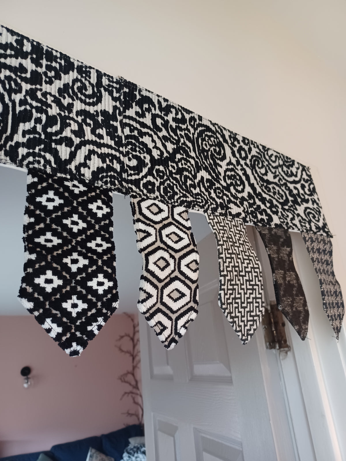 Handmade toran door hanging in shades of black and off-white