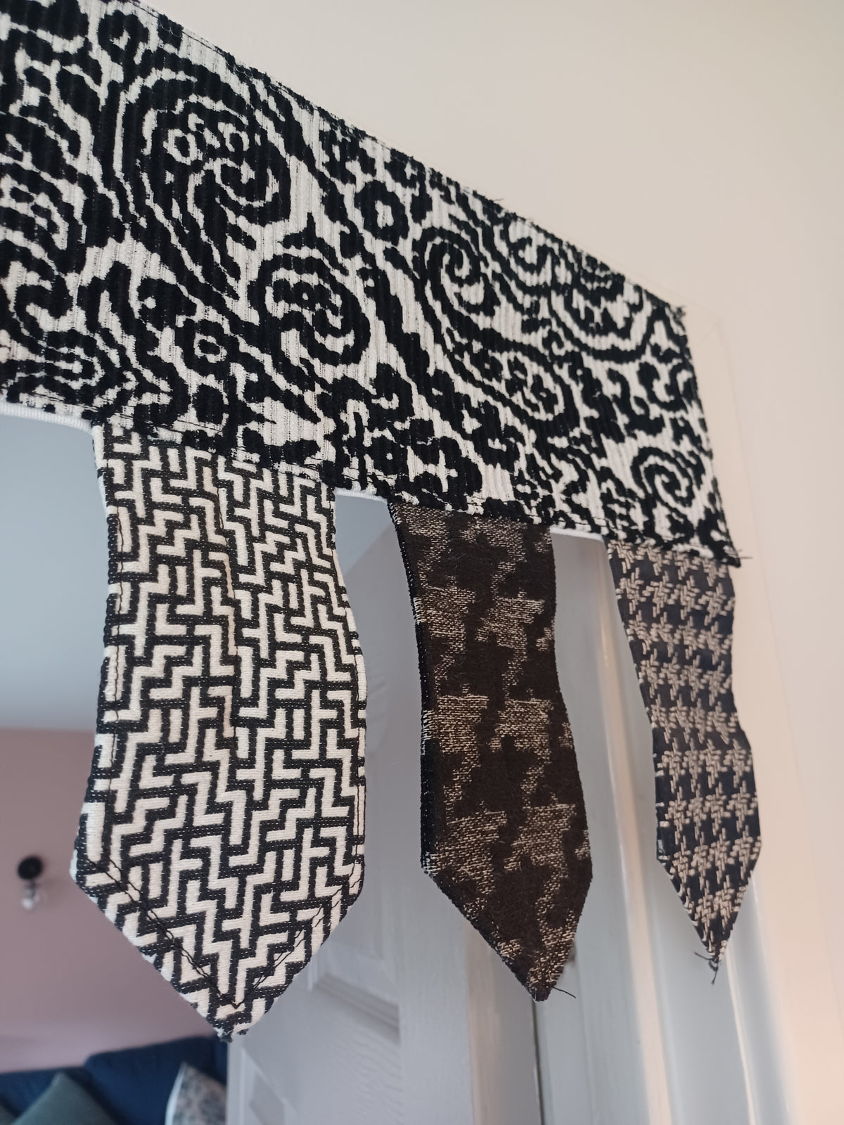 Handmade toran door hanging in shades of black and off-white