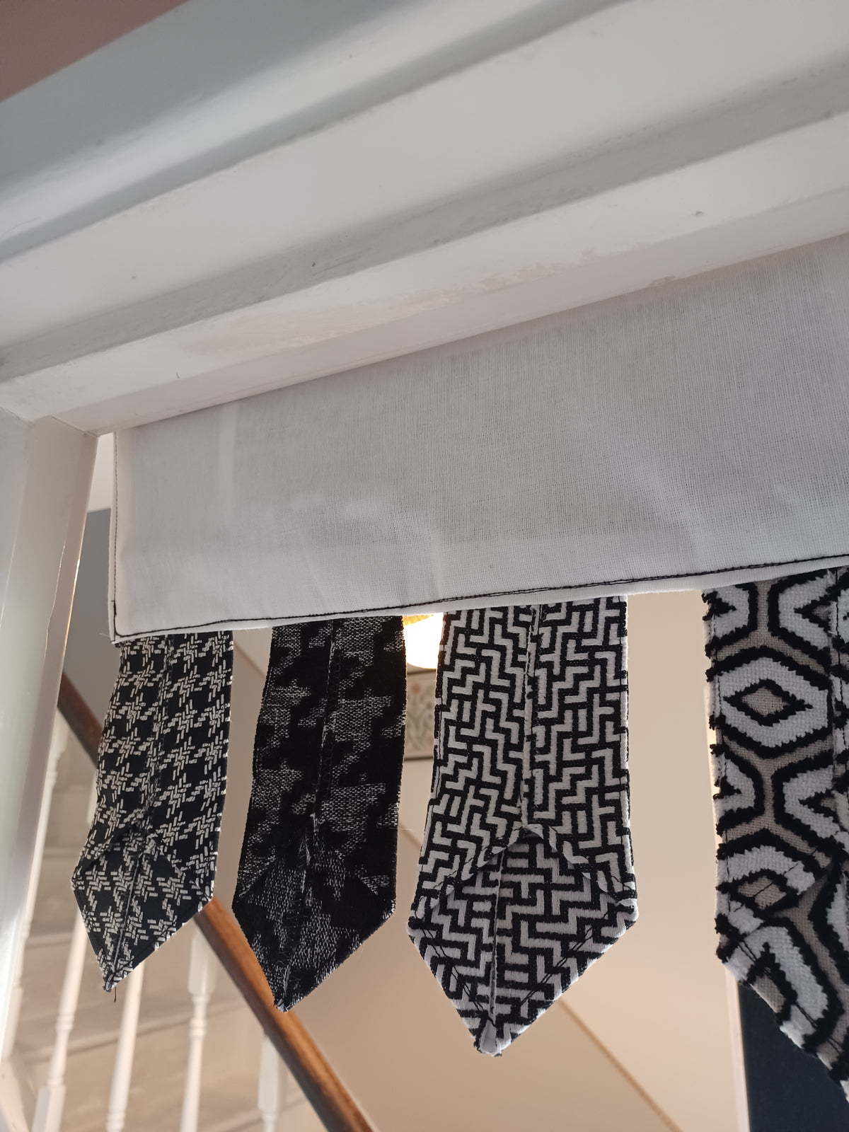 Handmade toran door hanging in shades of black and off-white