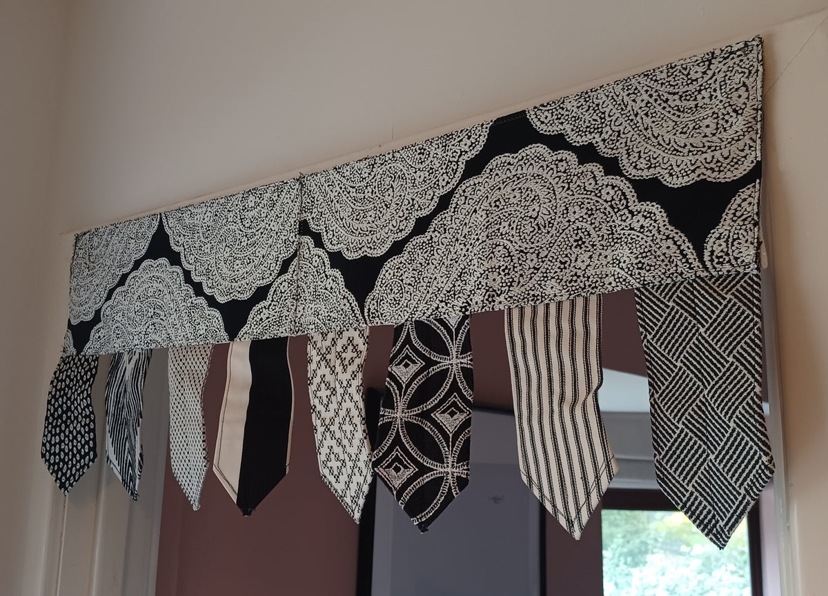 Handmade toran door hanging in shades of black and off-white