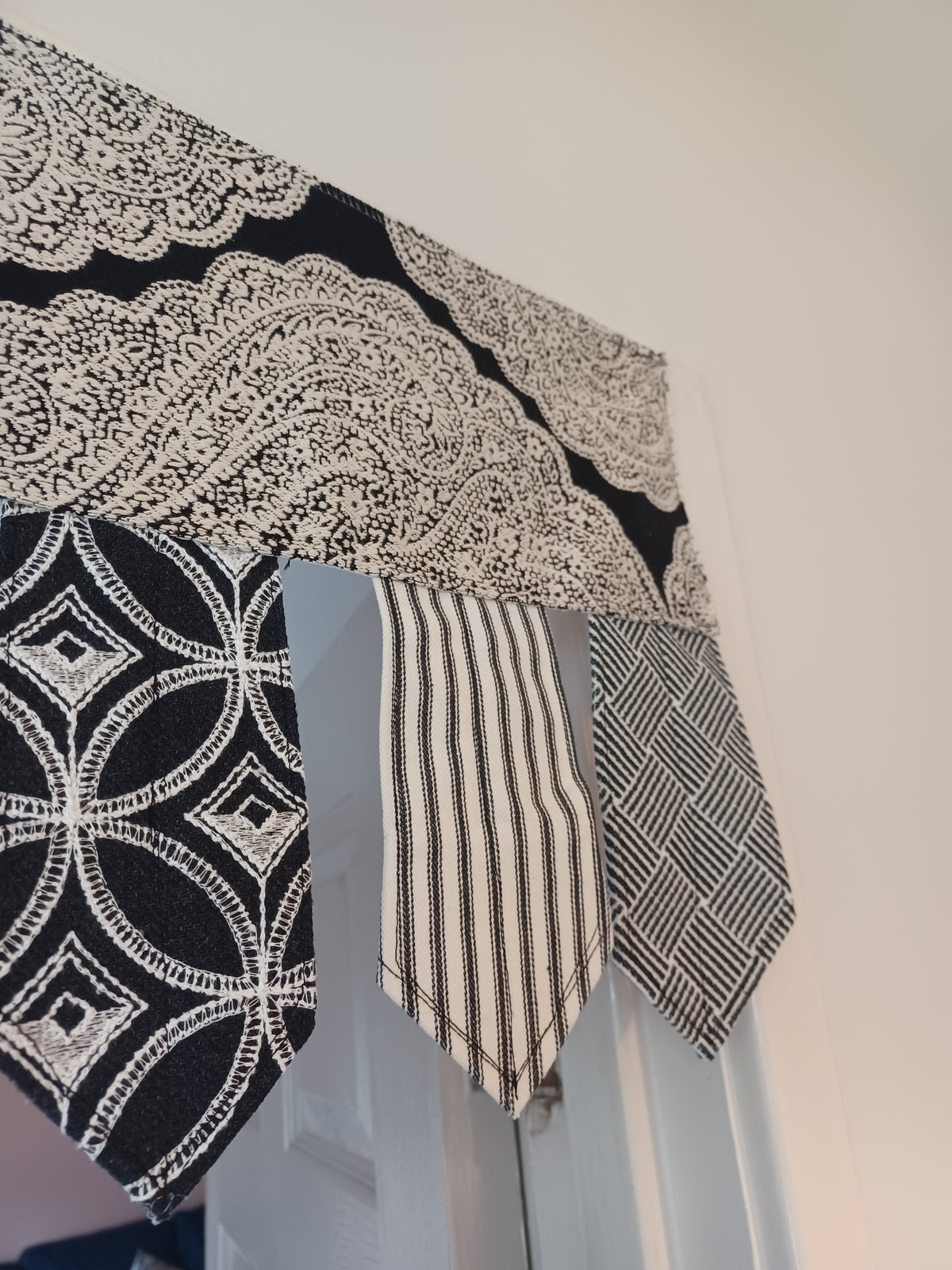 Handmade toran door hanging in shades of black and off-white