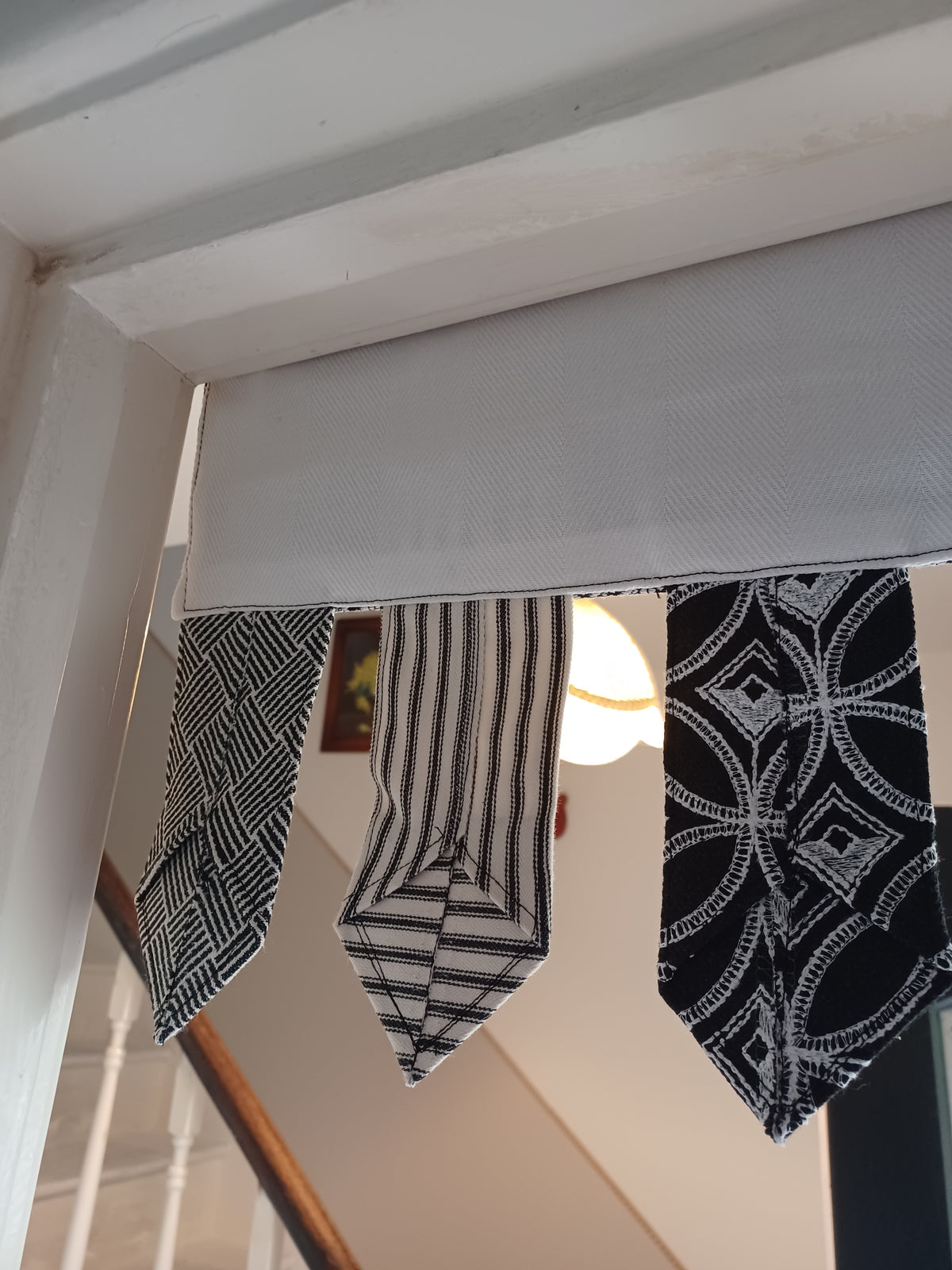 Handmade toran door hanging in shades of black and off-white