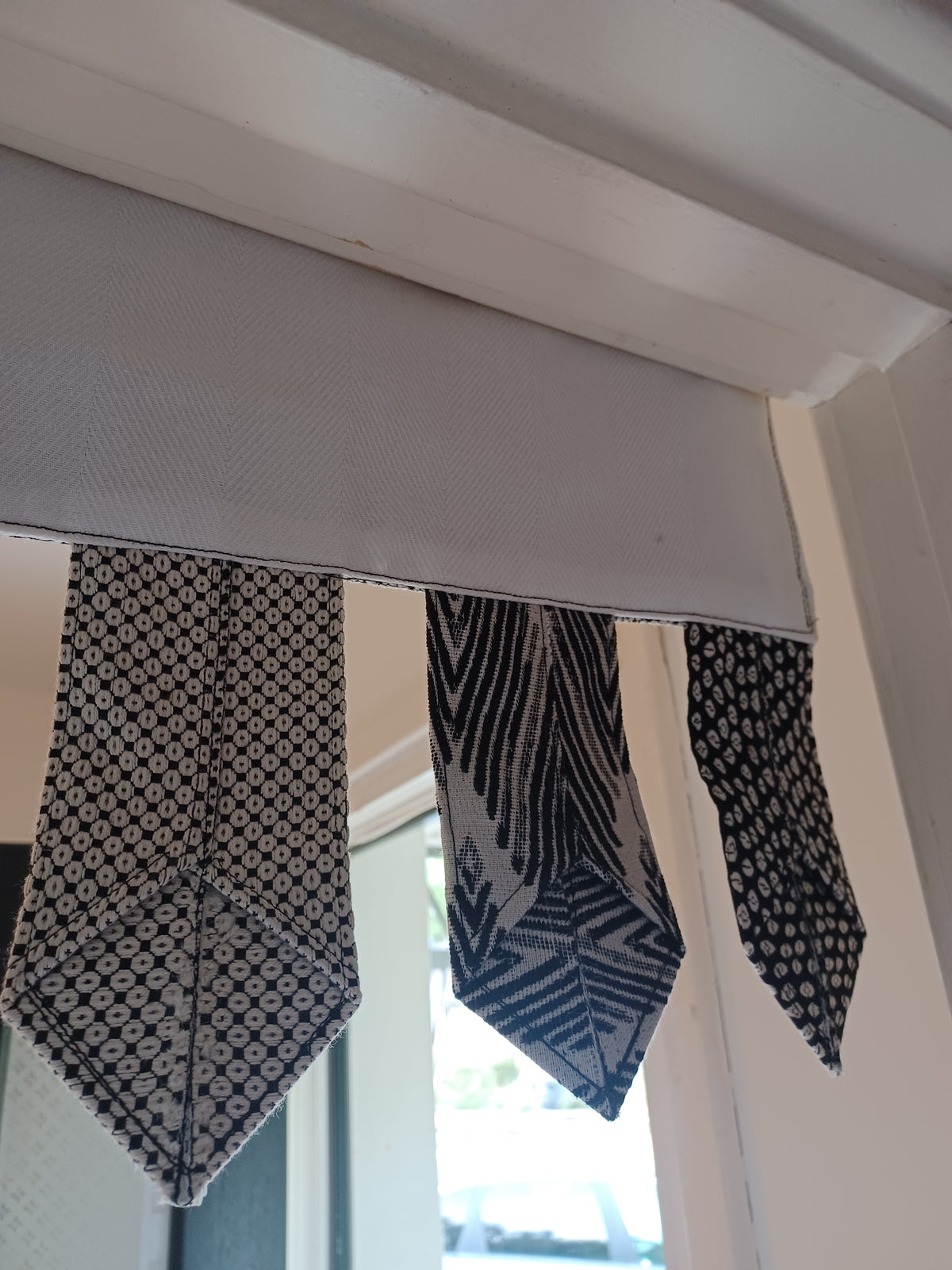 Handmade toran door hanging in shades of black and off-white